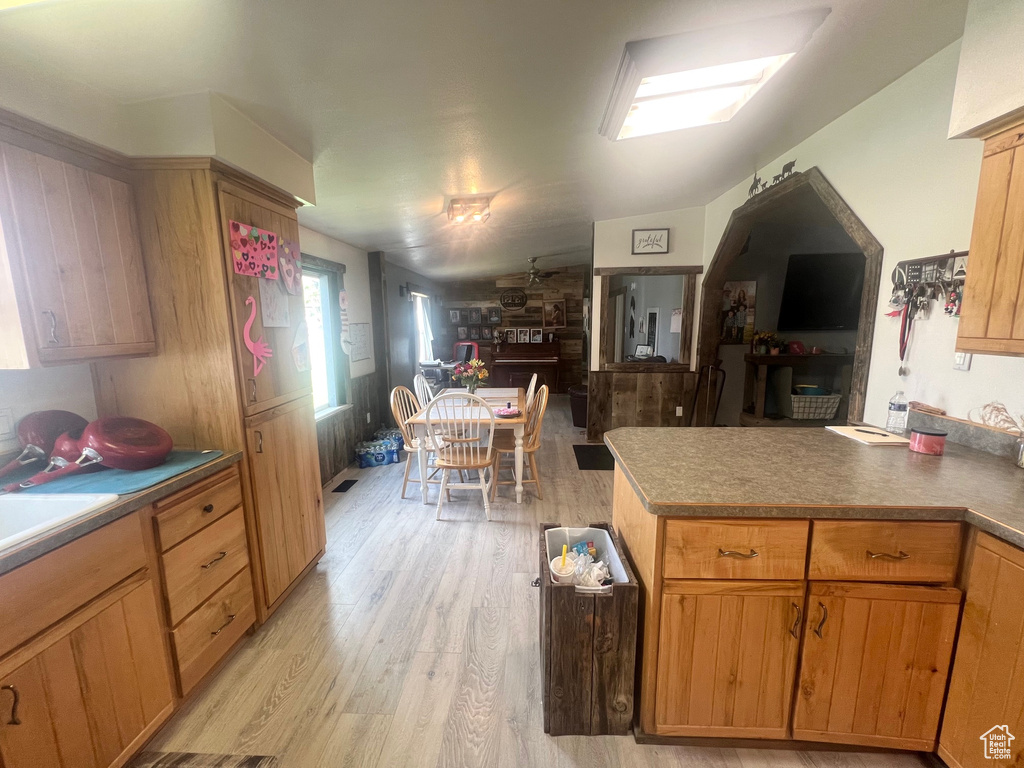 Kitchen featuring light wood-style floors and a peninsula