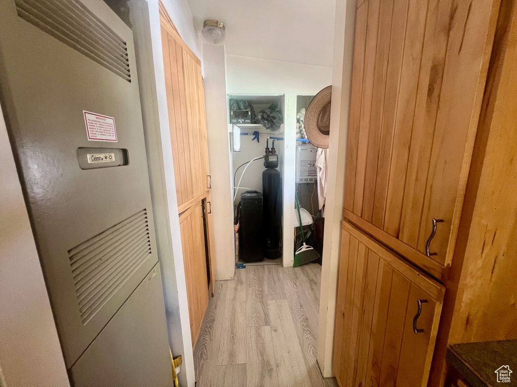 Hall featuring a heating unit and light wood-type flooring