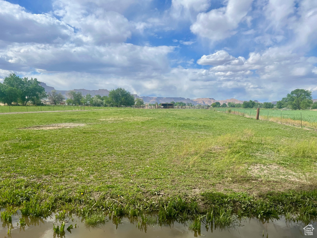 View of yard with a rural view and a mountain view