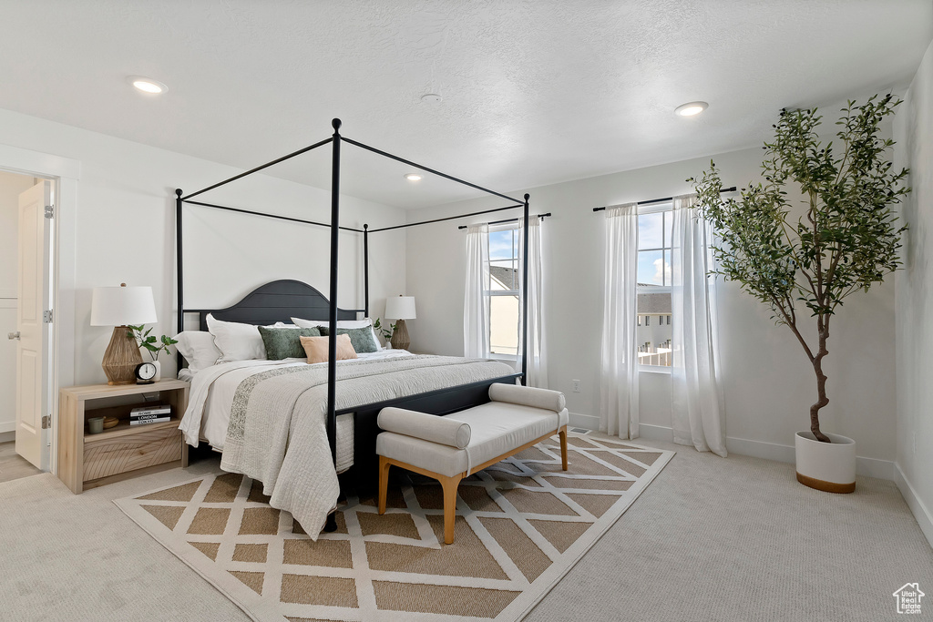 Bedroom featuring light colored carpet, recessed lighting, and baseboards