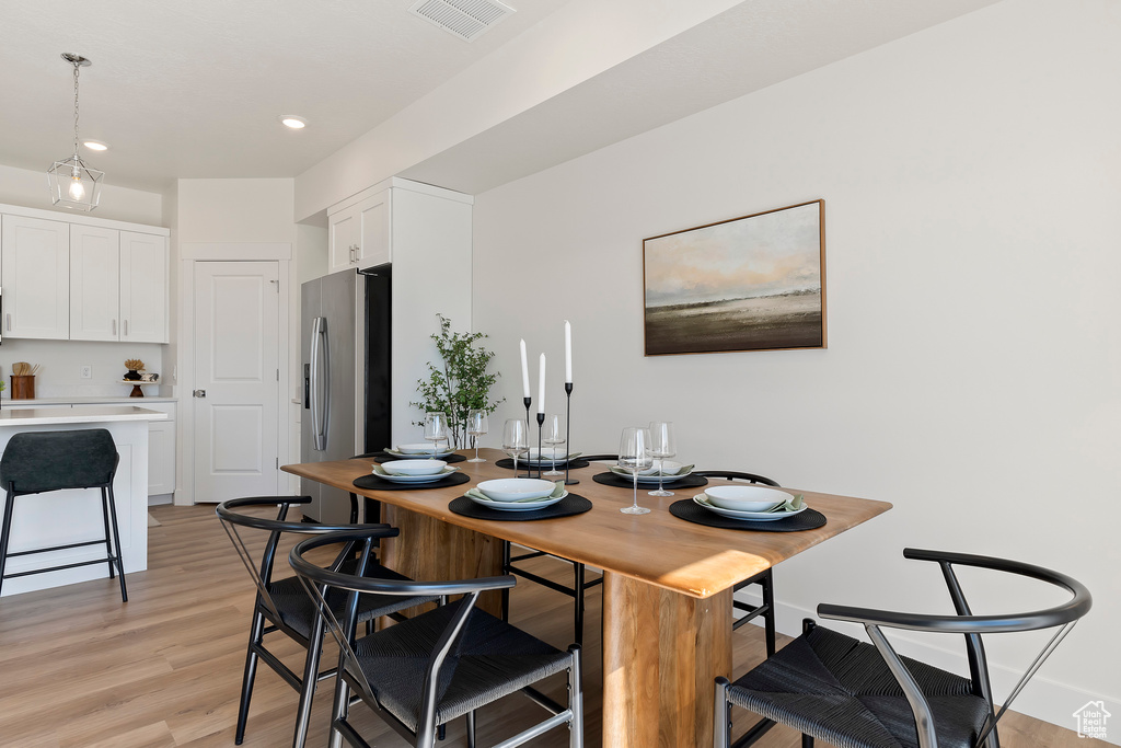 Dining space featuring light wood finished floors and recessed lighting