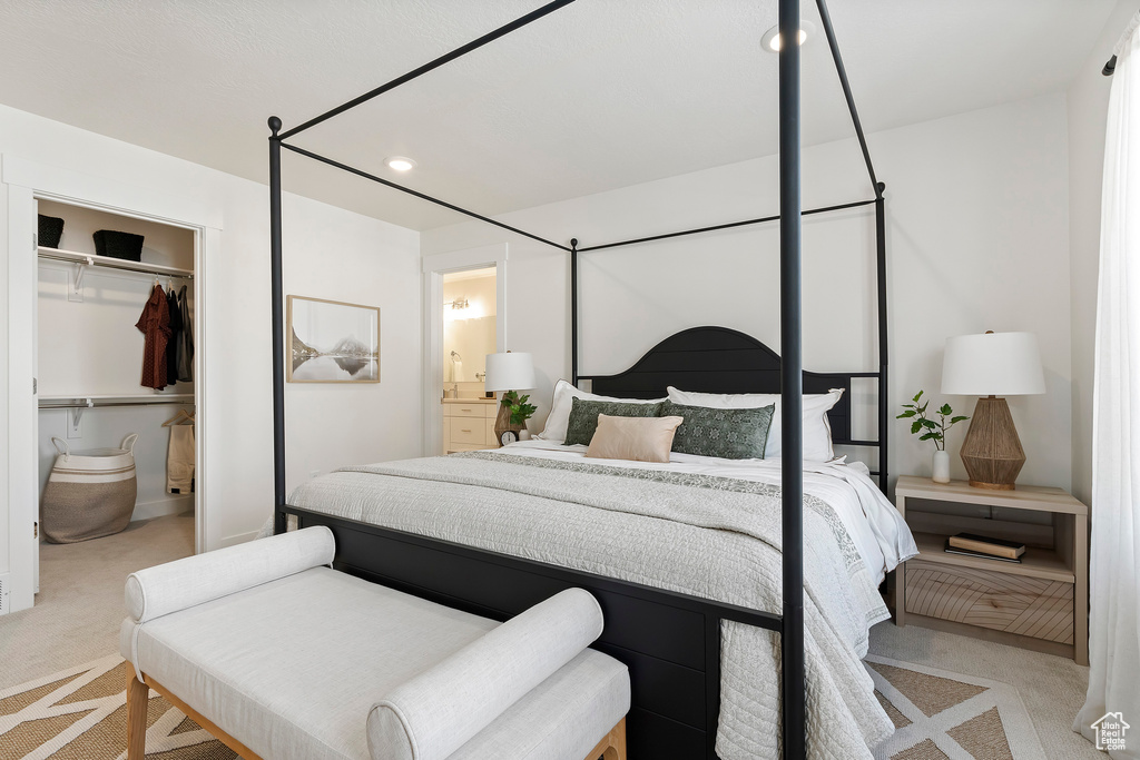 Carpeted bedroom featuring a closet, recessed lighting, and ensuite bath