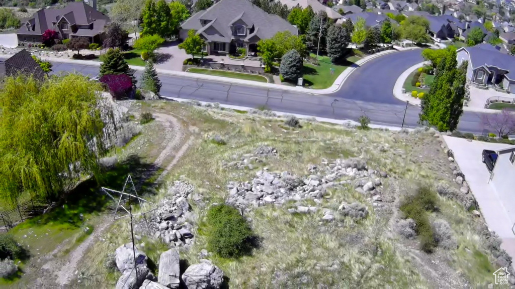 Aerial view of property and surrounding area featuring nearby suburban area