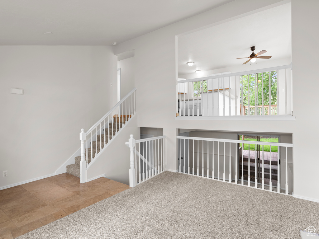 Unfurnished room featuring a ceiling fan and baseboards