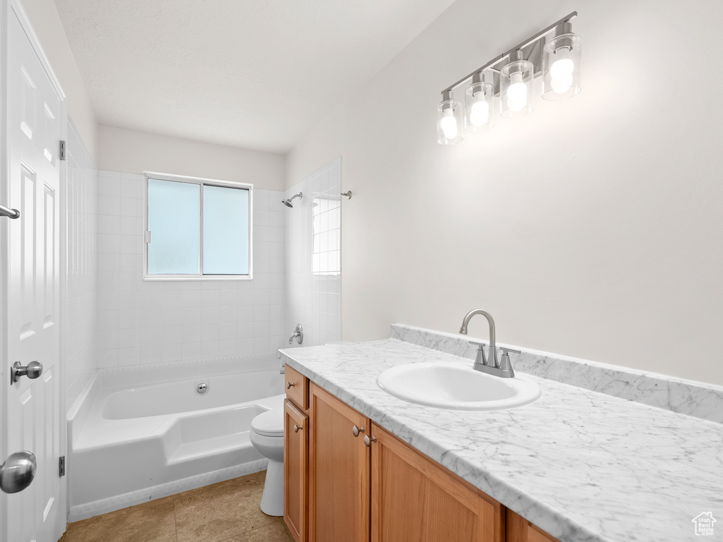 Full bath featuring vanity, toilet, washtub / shower combination, and tile patterned flooring