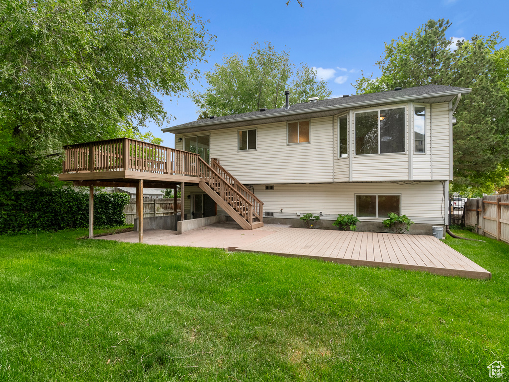 Rear view of property featuring a deck, a patio, and stairway