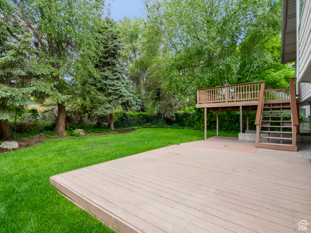 Wooden terrace with stairs and a yard