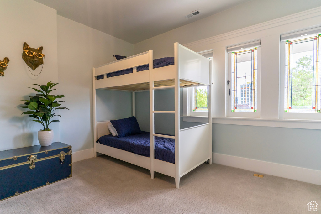 Bedroom featuring multiple windows, carpet, and baseboards
