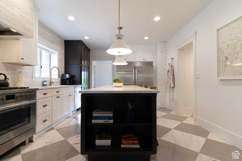 Kitchen featuring appliances with stainless steel finishes, open shelves, tasteful backsplash, white cabinetry, and recessed lighting