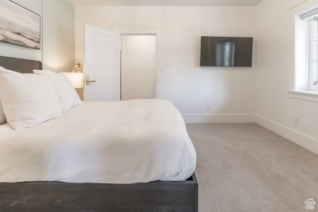 Bedroom featuring carpet flooring and baseboards