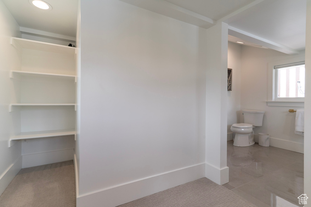 Bathroom featuring toilet and baseboards