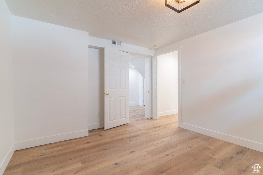 Unfurnished room featuring baseboards and light wood-type flooring