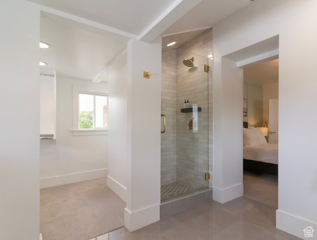 Ensuite bathroom featuring a shower stall, baseboards, and recessed lighting