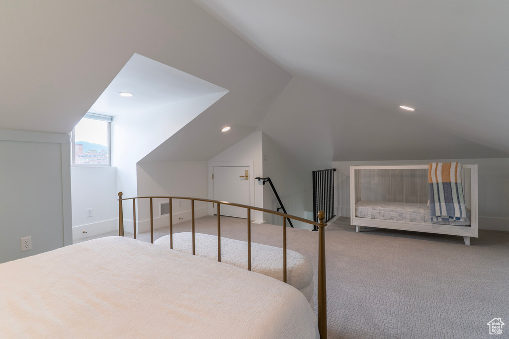 Bedroom featuring lofted ceiling, carpet floors, recessed lighting, and baseboards
