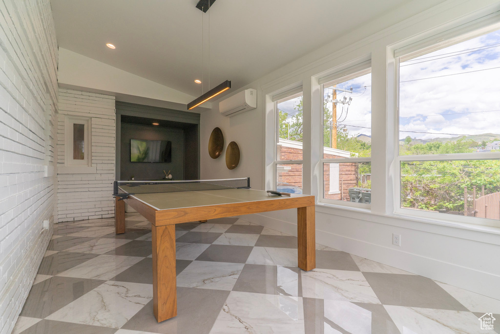 Playroom featuring a wall mounted AC, vaulted ceiling, recessed lighting, and baseboards