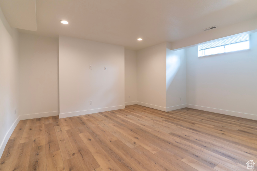 Unfurnished room with light wood finished floors, recessed lighting, and baseboards