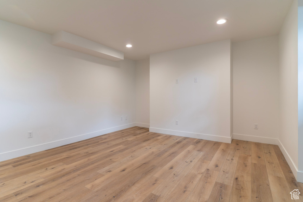 Empty room featuring recessed lighting, light wood finished floors, and baseboards