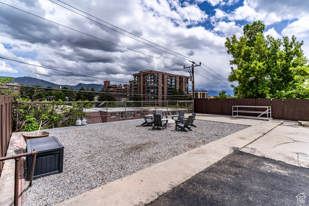 View of patio featuring a mountain view and fence