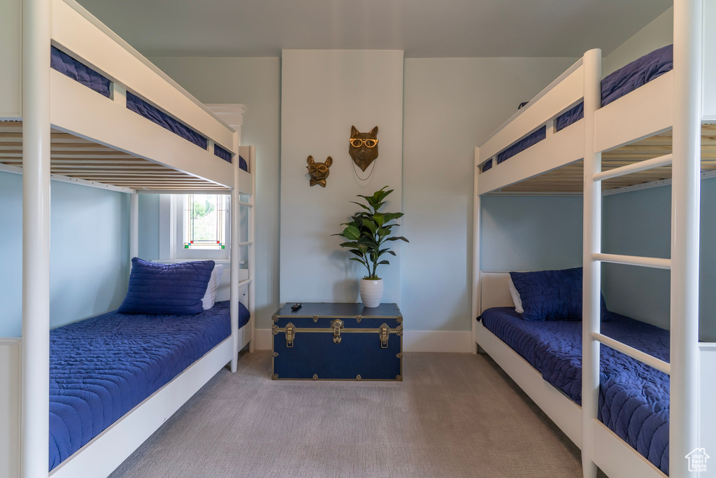 Carpeted bedroom featuring baseboards