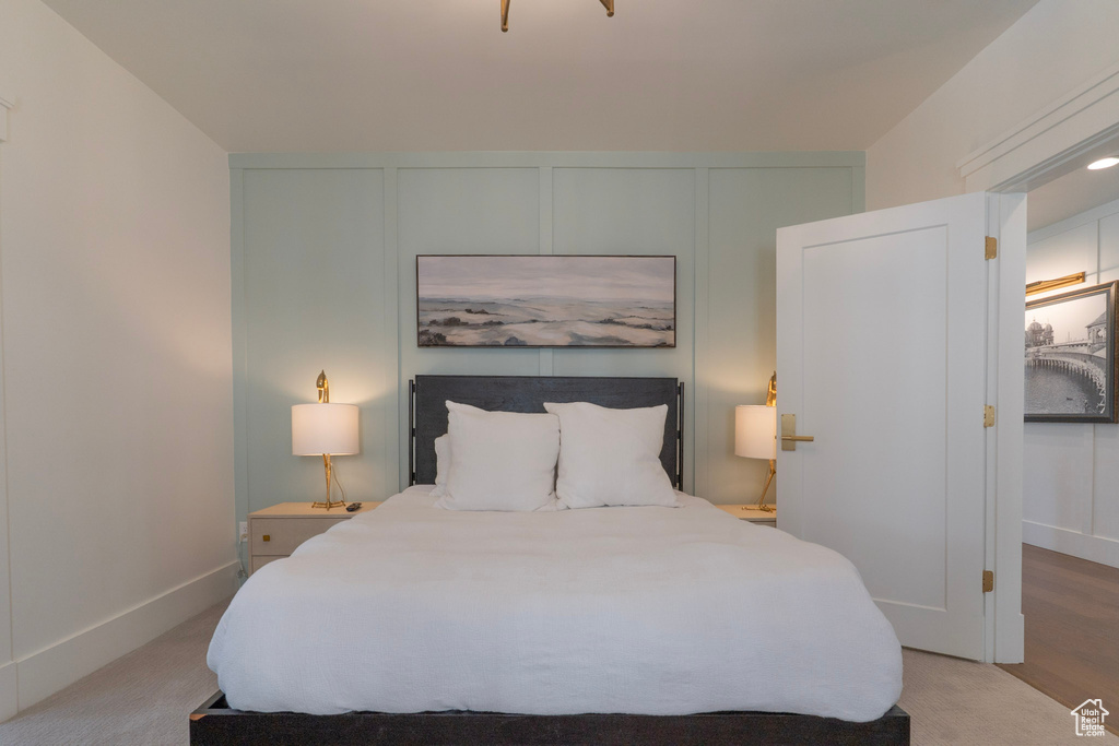 Bedroom featuring a decorative wall