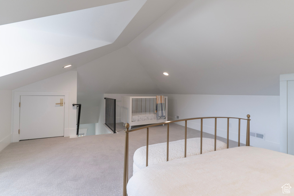 Unfurnished bedroom featuring lofted ceiling, carpet flooring, and recessed lighting