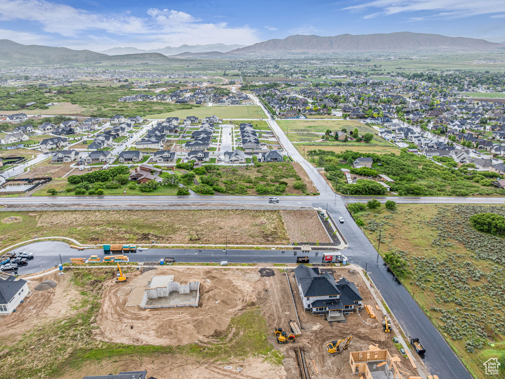 Aerial view of property and surrounding area featuring a mountain backdrop