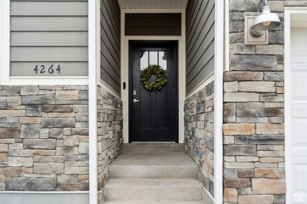 Doorway to property with stone siding