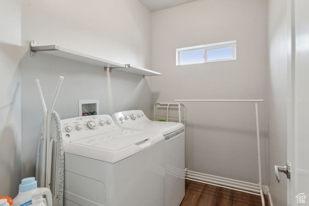 Laundry area featuring independent washer and dryer and dark wood-type flooring