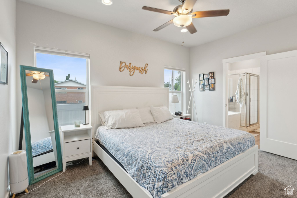 Carpeted bedroom with ensuite bathroom and a ceiling fan