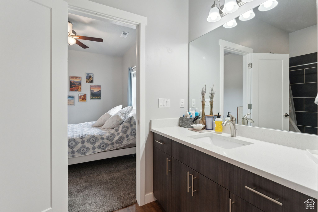 Bathroom with vanity, ceiling fan, and ensuite bathroom