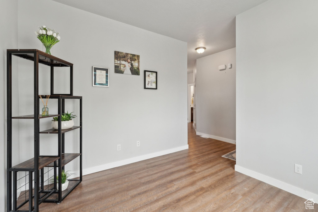 Unfurnished room featuring wood finished floors and baseboards