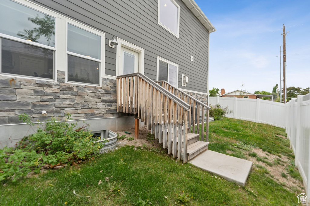 Entrance to property featuring stone siding