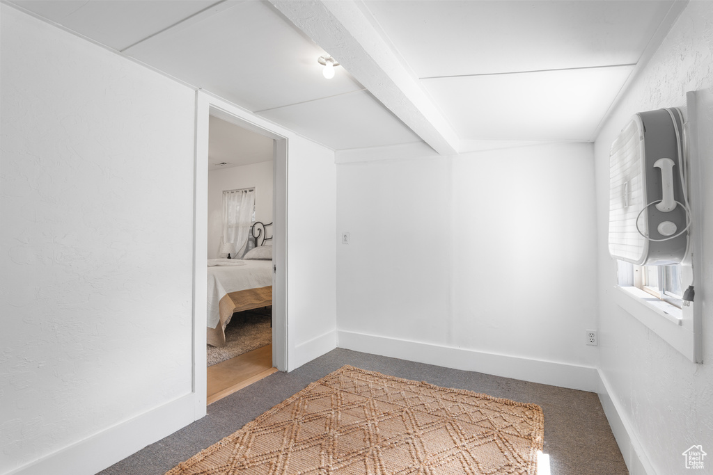 Hallway featuring carpet flooring and baseboards