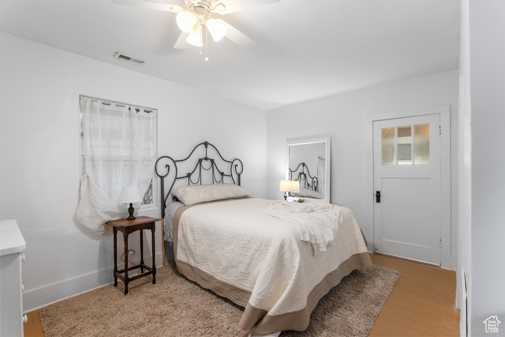 Bedroom with wood finished floors and a ceiling fan