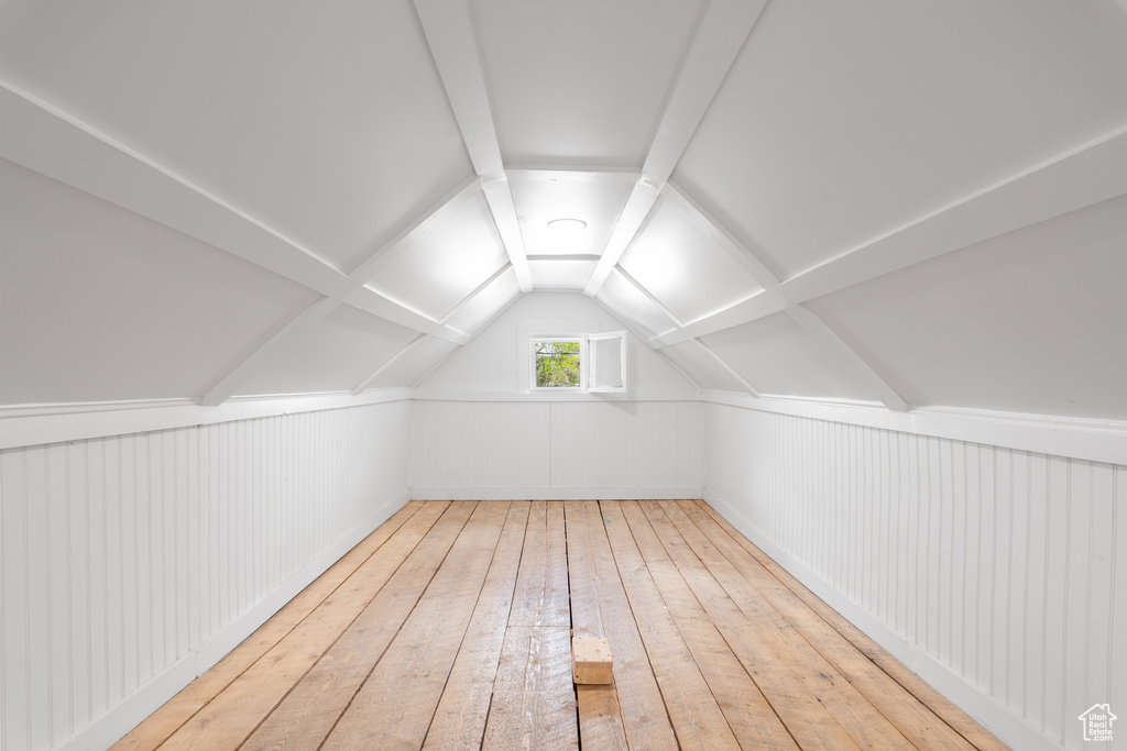 Additional living space featuring hardwood / wood-style floors and lofted ceiling