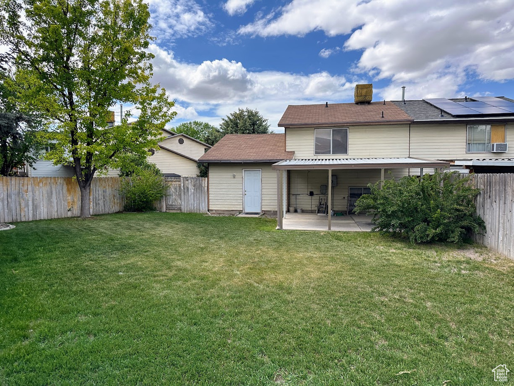 Back of property featuring a patio and a chimney
