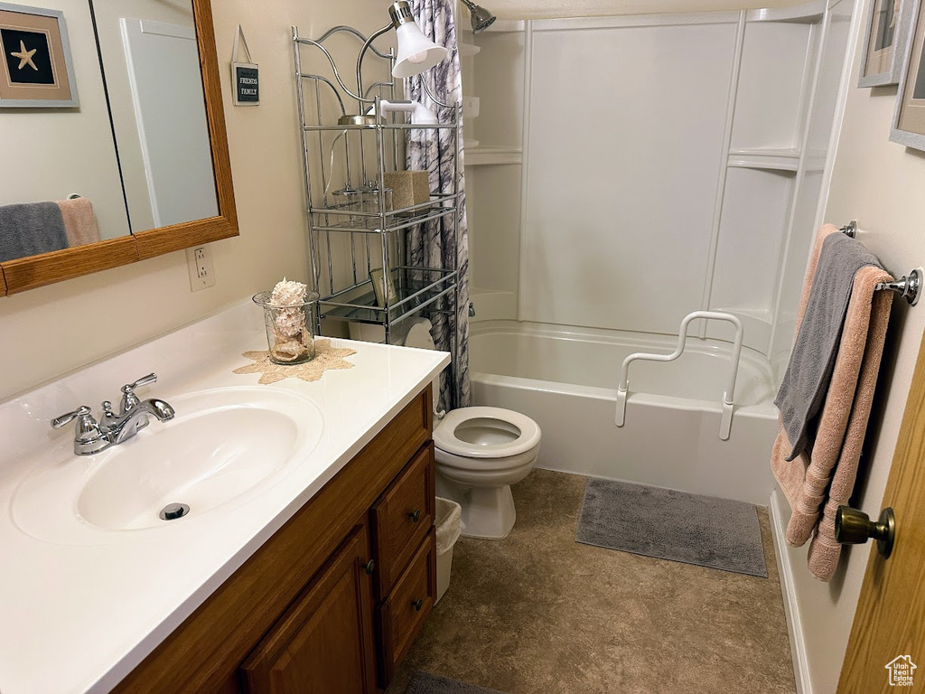 Bathroom featuring toilet, vanity, and washtub / shower combination
