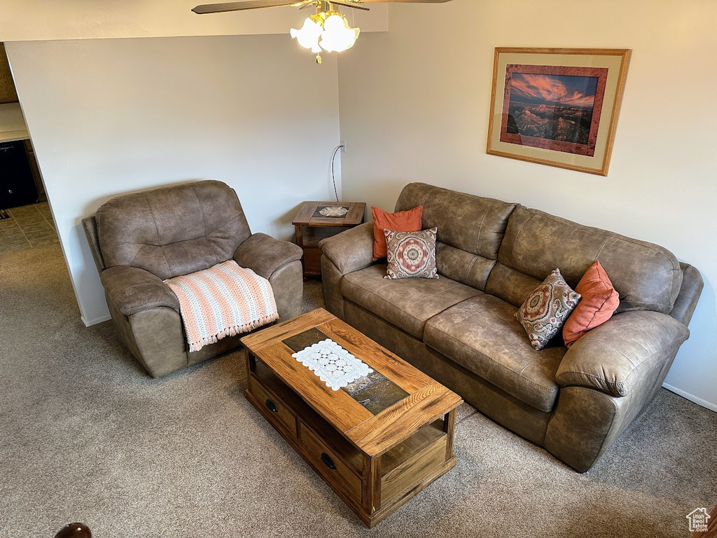 Living area featuring carpet and ceiling fan