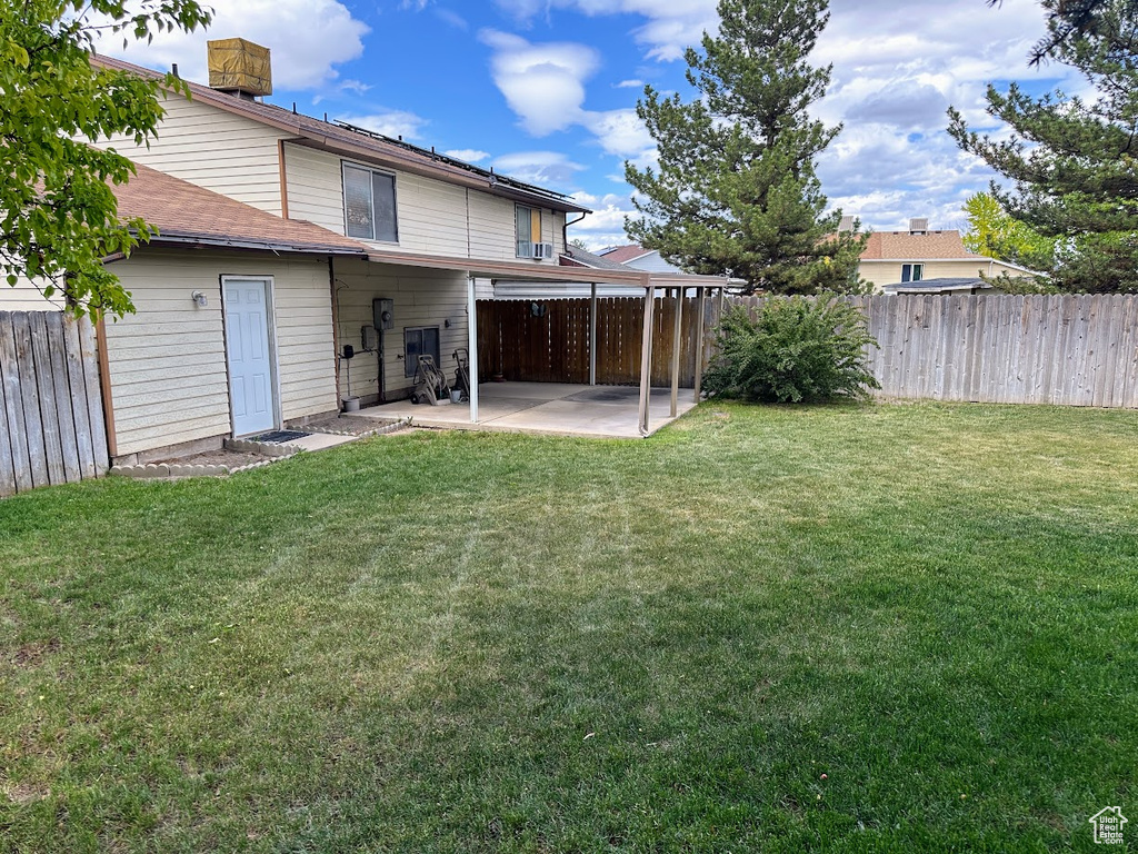 Back of property featuring a patio area and roof with shingles