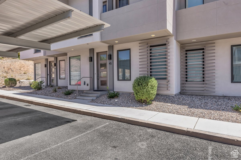 Property entrance featuring stucco siding