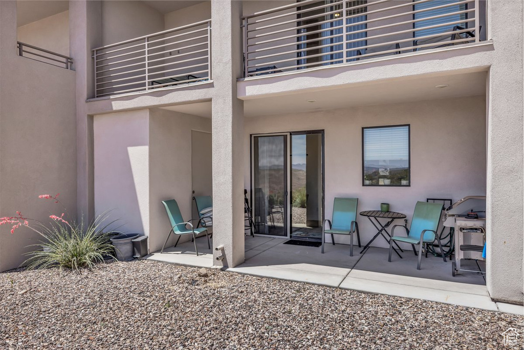 View of patio featuring a balcony