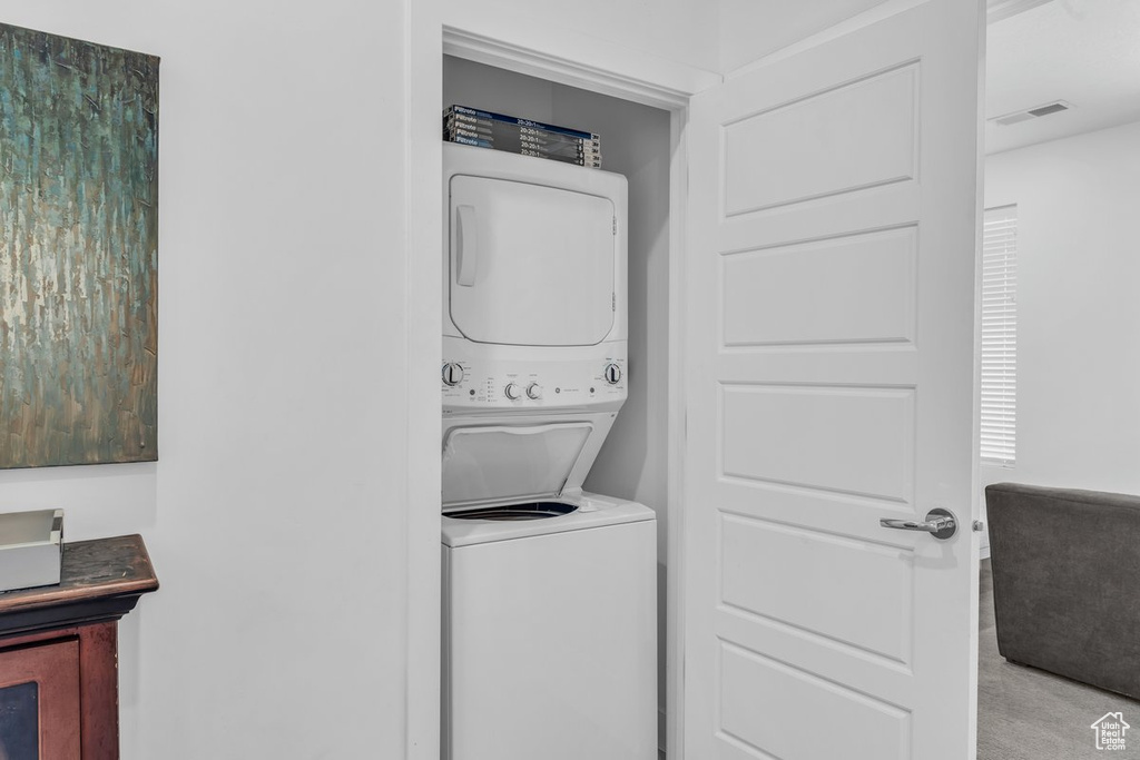 Clothes washing area with stacked washing machine and dryer