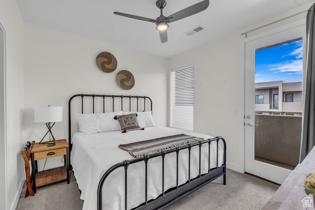 Bedroom featuring light carpet, baseboards, ceiling fan, and multiple windows