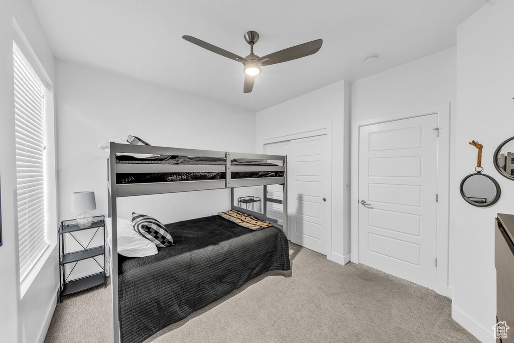 Bedroom featuring carpet flooring, ceiling fan, baseboards, and a closet