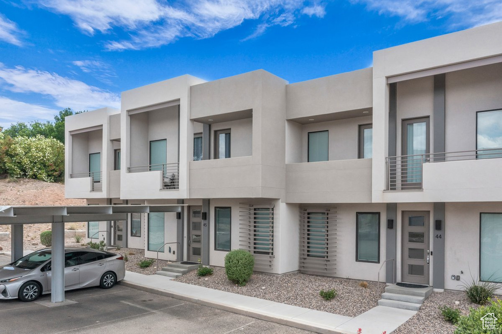View of property with covered parking