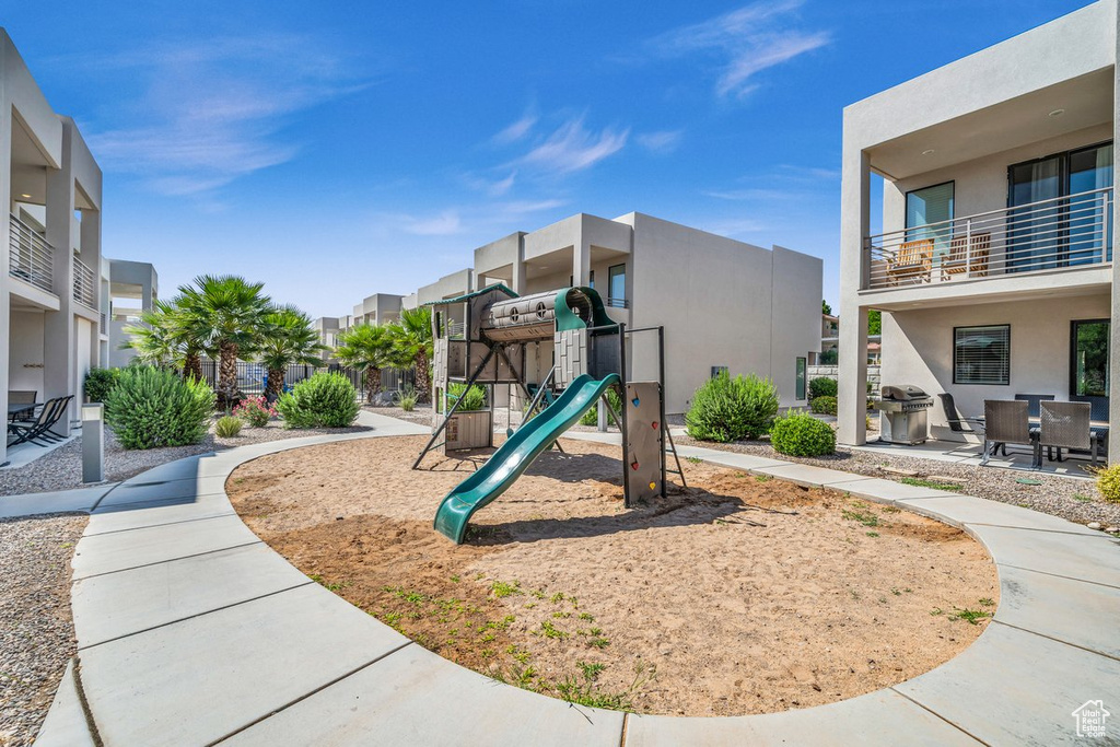 Community jungle gym with a residential view and a patio