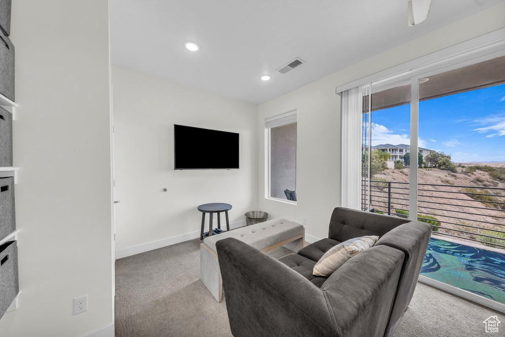 Carpeted living room with baseboards and recessed lighting