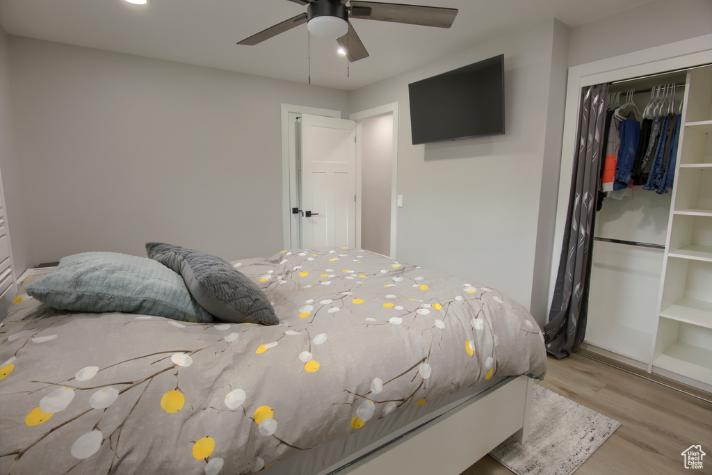Bedroom featuring wood finished floors, a closet, and ceiling fan