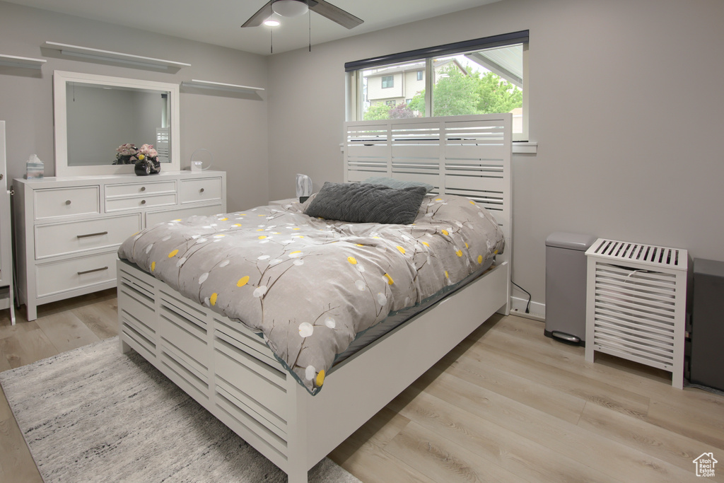 Bedroom with light wood-style flooring and a ceiling fan
