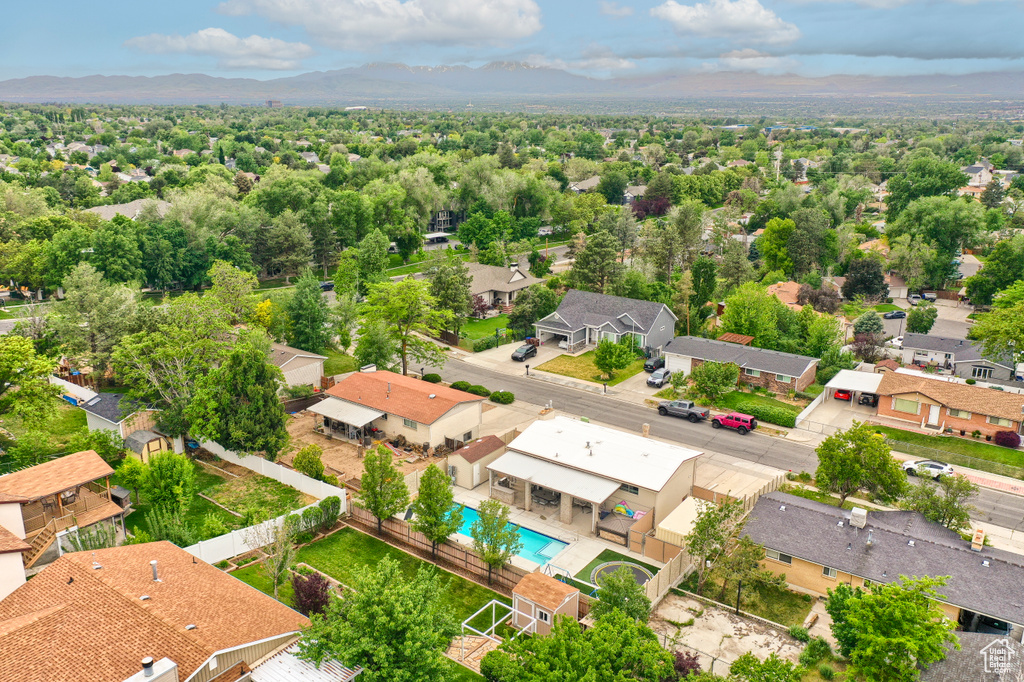 Aerial view of residential area with mountains and a pool